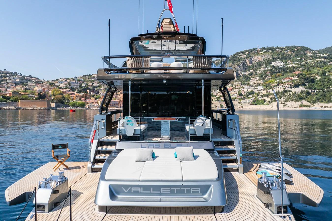 The yacht's aft deck offers a luxurious lounging area with stunning views of the surrounding coastline. aboard L'AS BLEU Yacht for Sale