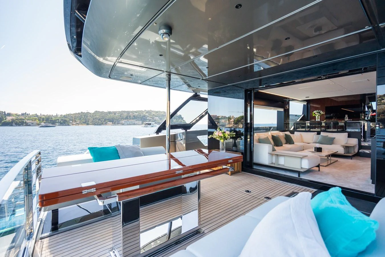 The aft deck features a spacious seating area with a seamless transition to the luxurious interior salon. aboard L'AS BLEU Yacht for Sale