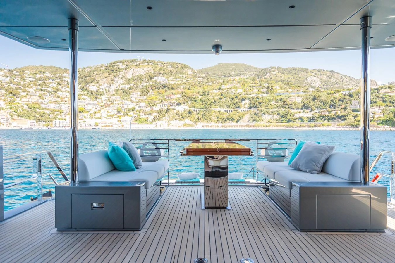 The aft deck offers a serene seating area with stunning views of the surrounding landscape. aboard L'AS BLEU Yacht for Sale