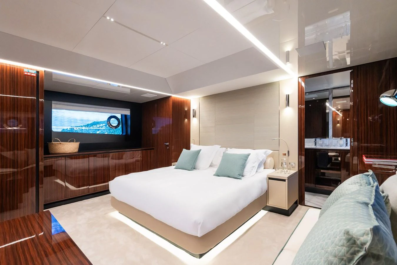 The master stateroom features a luxurious bed, elegant wood paneling, and modern lighting. aboard L'AS BLEU Yacht for Sale