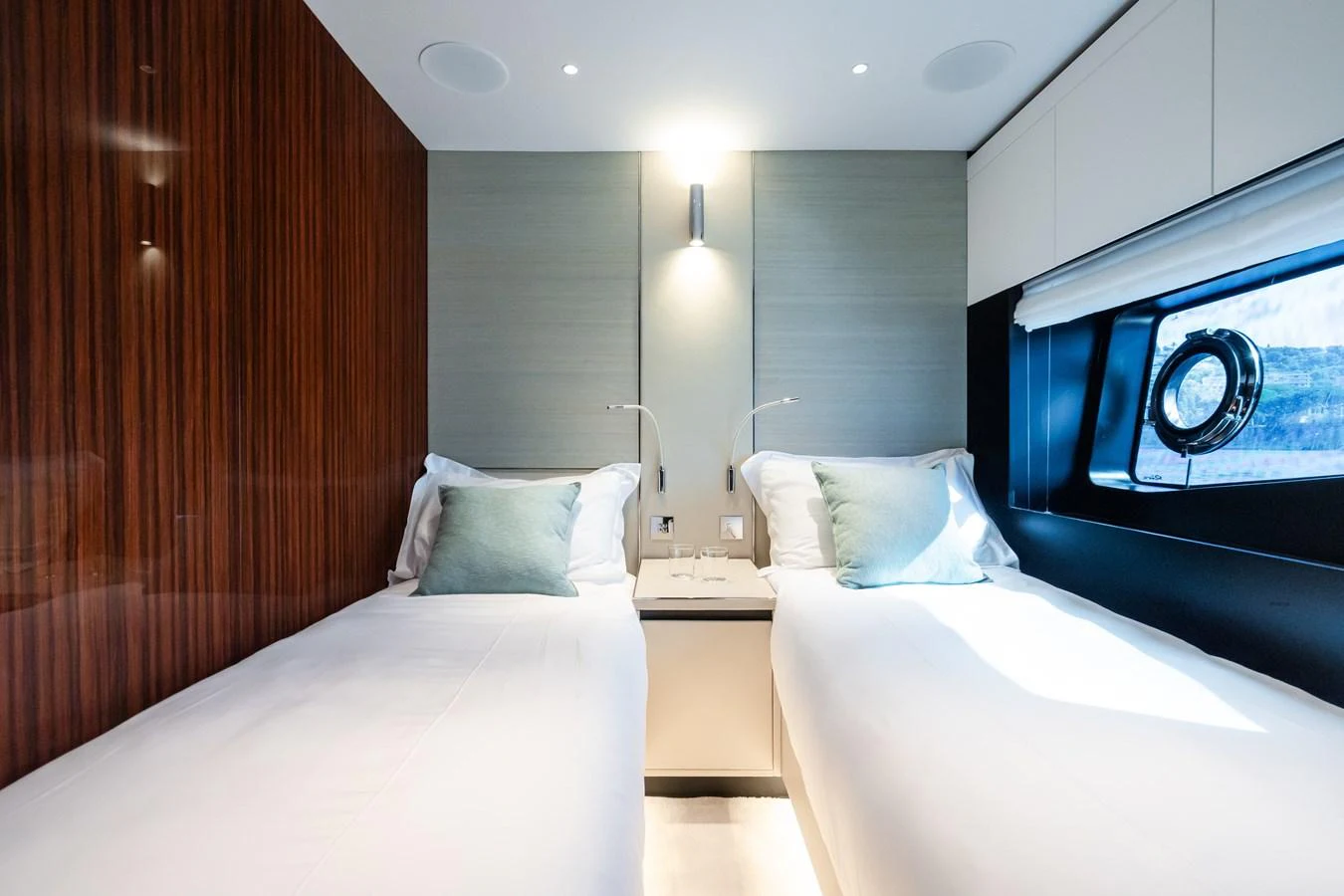 A modern twin stateroom with sleek design and ample natural light. aboard L'AS BLEU Yacht for Sale