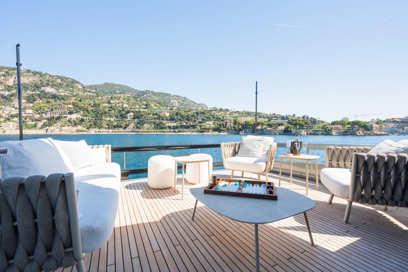 The aft deck offers a luxurious outdoor seating area with stunning views of the coastline. aboard L'AS BLEU Yacht for Sale