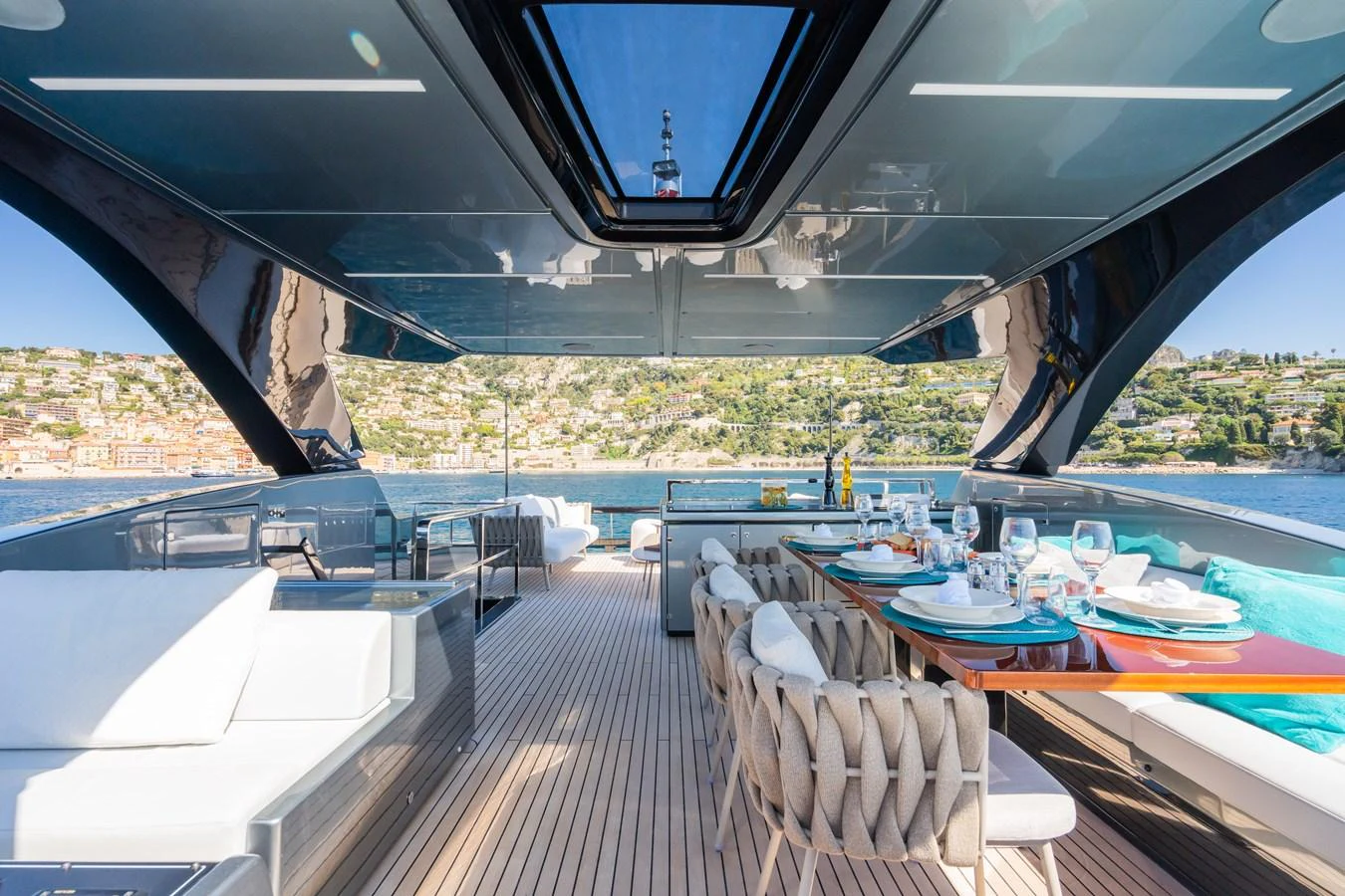 The aft deck offers a luxurious dining area with stunning views of the surrounding landscape. aboard L'AS BLEU Yacht for Sale