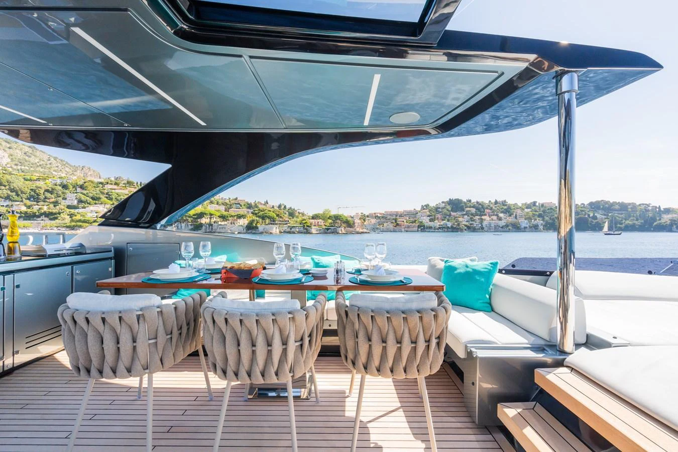 The aft deck features a stylish dining area with a scenic view of the water. aboard L'AS BLEU Yacht for Sale
