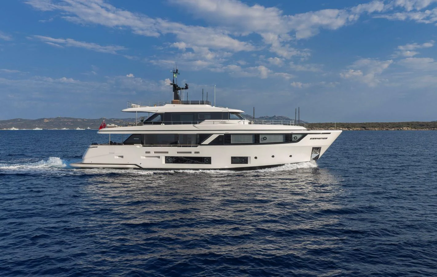 A sleek and modern yacht cruises gracefully on the open sea under a clear blue sky. aboard CLAIRE DE LUNE Yacht for Sale