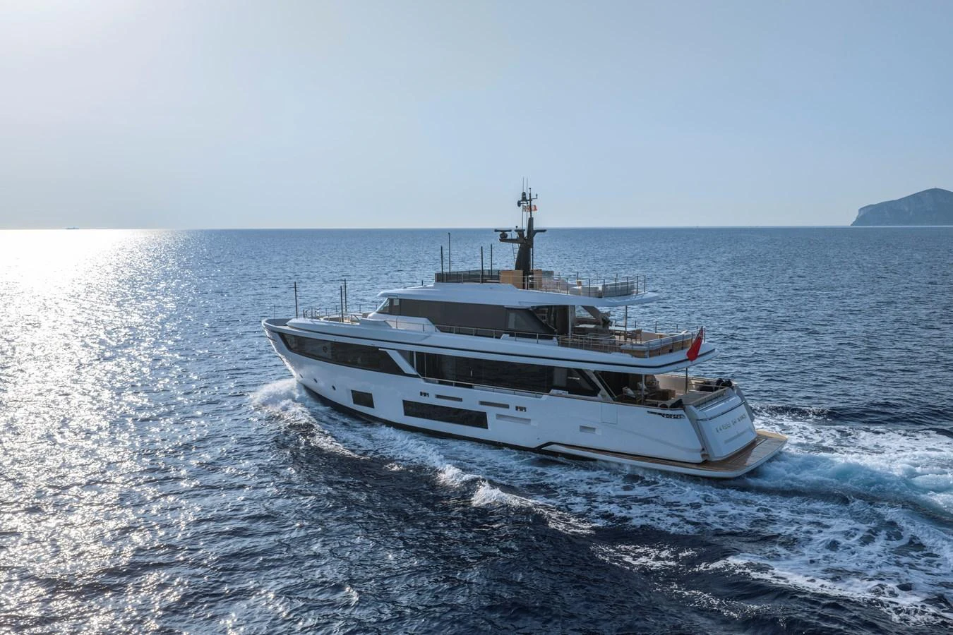 A sleek and modern yacht cruises through open waters under a clear sky. aboard CLAIRE DE LUNE Yacht for Sale