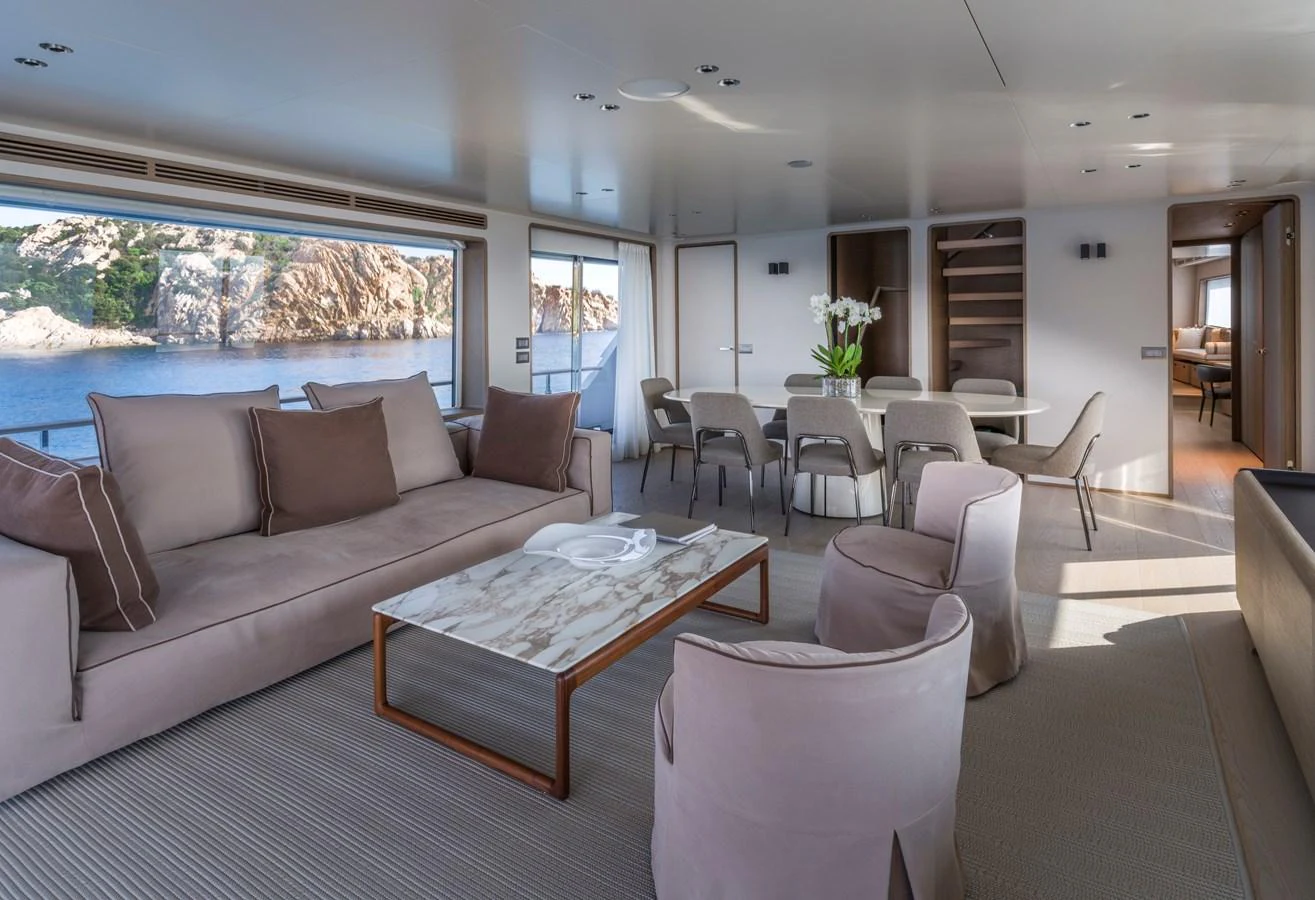 The salon offers a spacious and elegant seating area with large windows providing stunning views. aboard CLAIRE DE LUNE Yacht for Sale