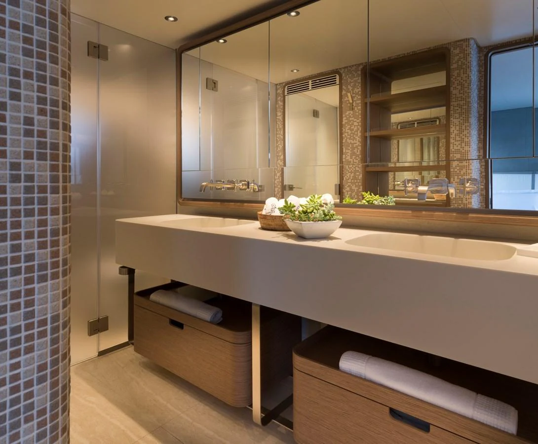 The yacht's bathroom features a modern design with a large mirror and ample storage space. aboard CLAIRE DE LUNE Yacht for Sale