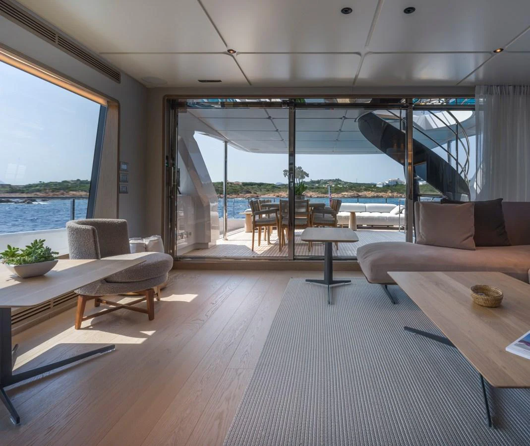 The salon offers a seamless transition to the aft deck with large sliding glass doors and comfortable seating. aboard CLAIRE DE LUNE Yacht for Sale