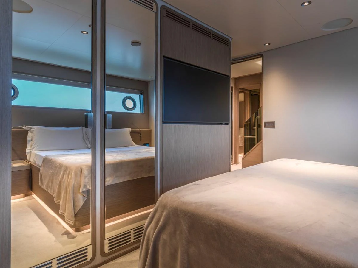 The stateroom features a comfortable bed, mirrored closet doors, and ambient lighting. aboard CLAIRE DE LUNE Yacht for Sale