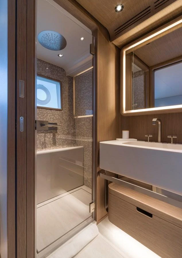 A sleek and modern bathroom with elegant fixtures and ambient lighting. aboard CLAIRE DE LUNE Yacht for Sale