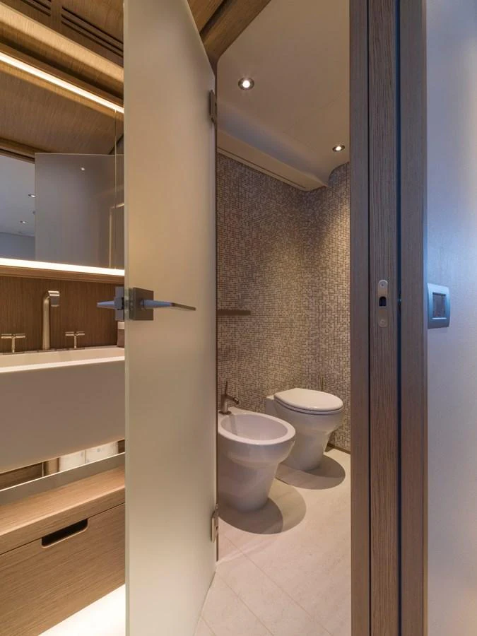 A modern yacht bathroom featuring a sleek design with a toilet and bidet. aboard CLAIRE DE LUNE Yacht for Sale