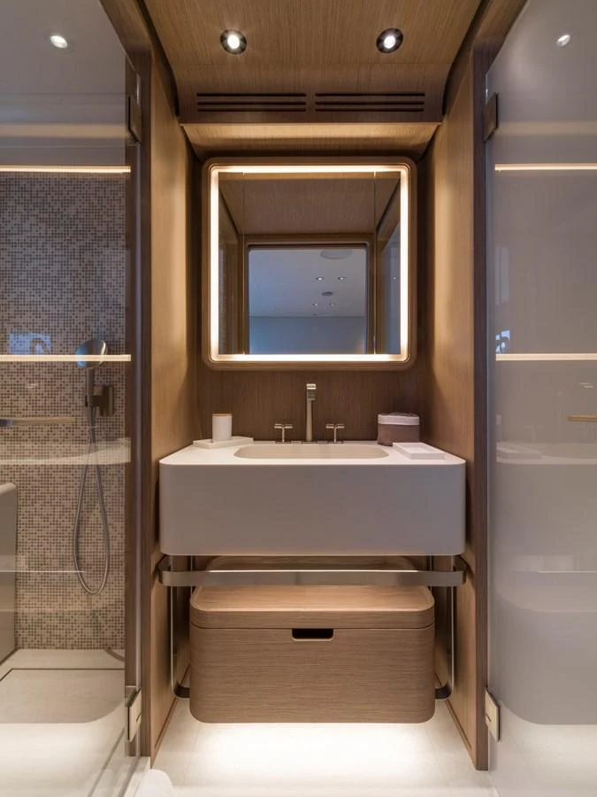 The yacht's bathroom features a modern sink with elegant lighting and a sleek design. aboard CLAIRE DE LUNE Yacht for Sale