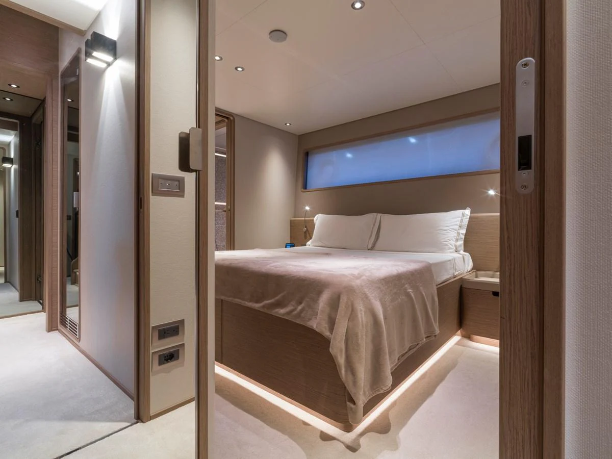 The stateroom features a luxurious bed with ambient lighting and modern decor. aboard CLAIRE DE LUNE Yacht for Sale