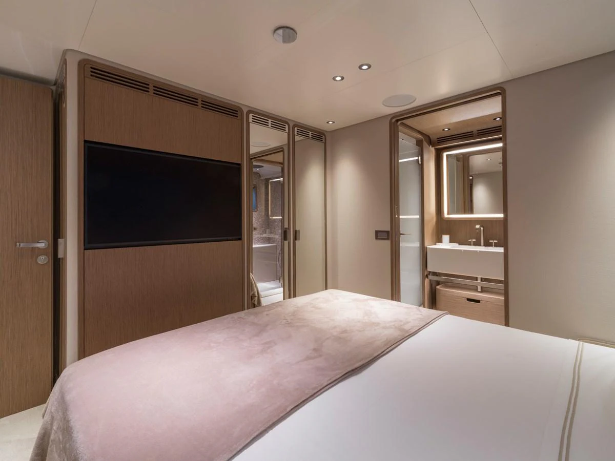 The guest stateroom features a cozy bed, modern lighting, and an en-suite bathroom. aboard CLAIRE DE LUNE Yacht for Sale