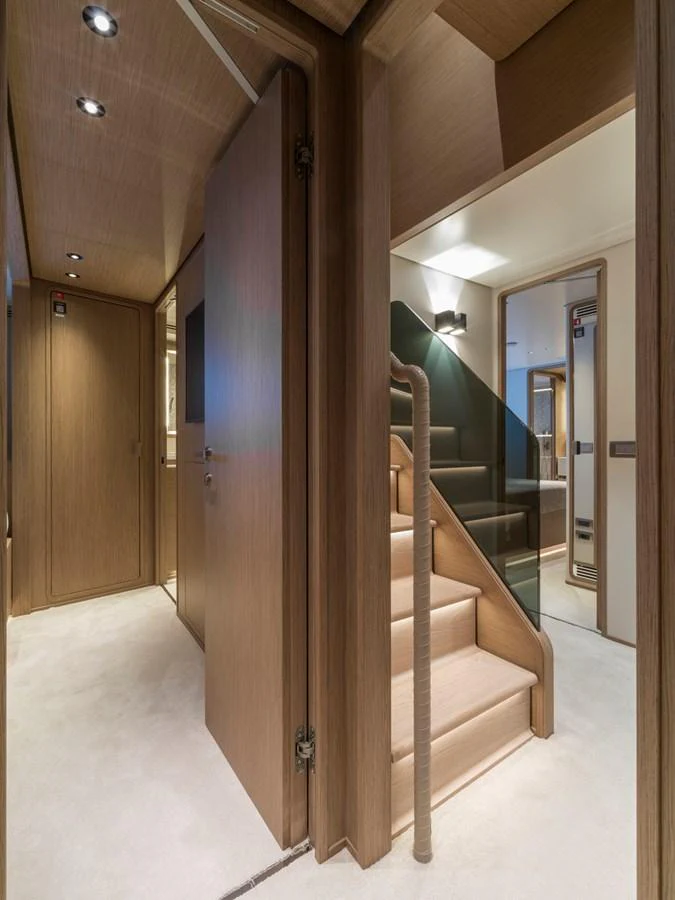 A modern and elegant interior hallway with a staircase leading to another level. aboard CLAIRE DE LUNE Yacht for Sale
