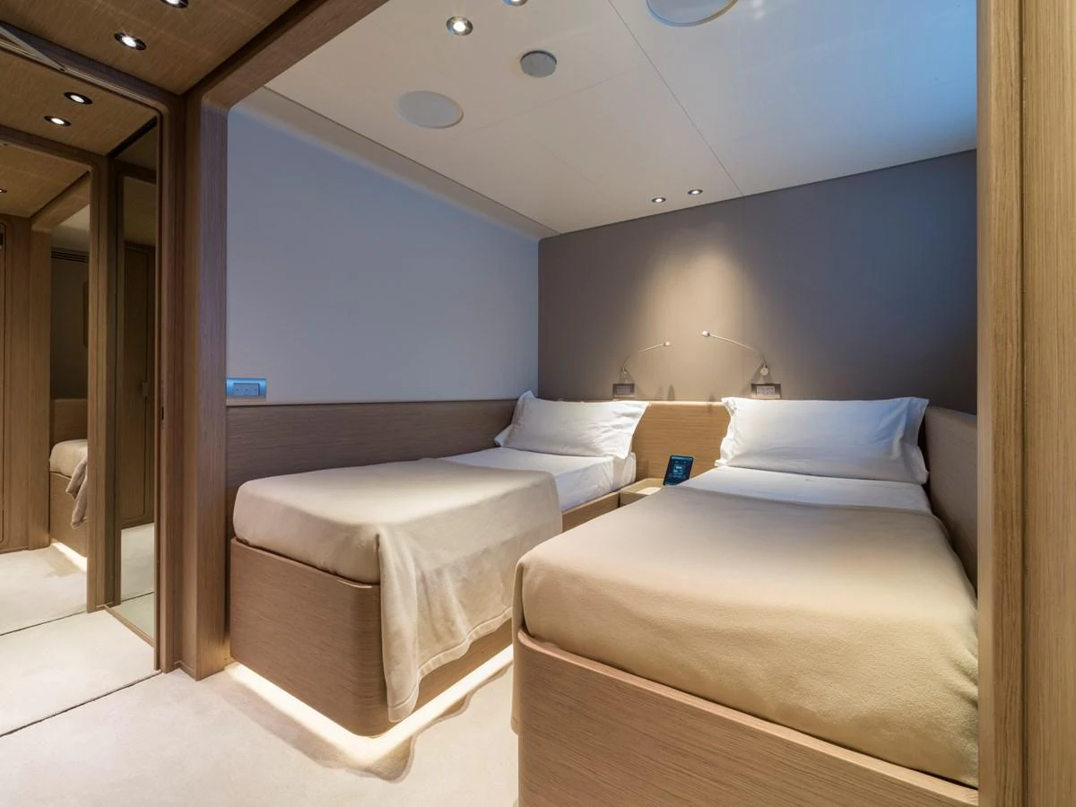 The guest stateroom features twin beds with modern, minimalist decor. aboard CLAIRE DE LUNE Yacht for Sale