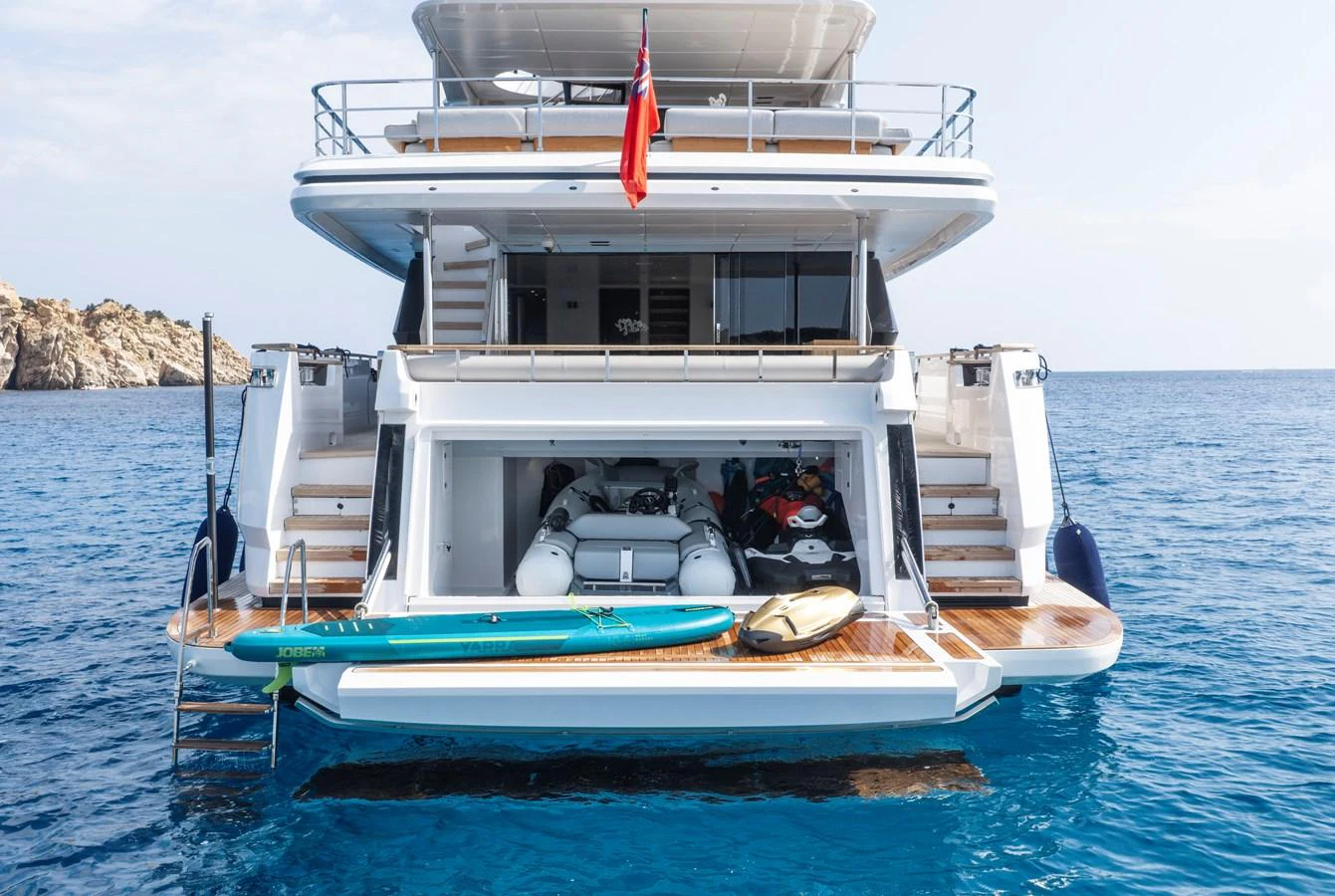 The yacht's aft deck features a spacious swim platform with water toys and a tender, perfect for aquatic adventures. aboard CLAIRE DE LUNE Yacht for Sale