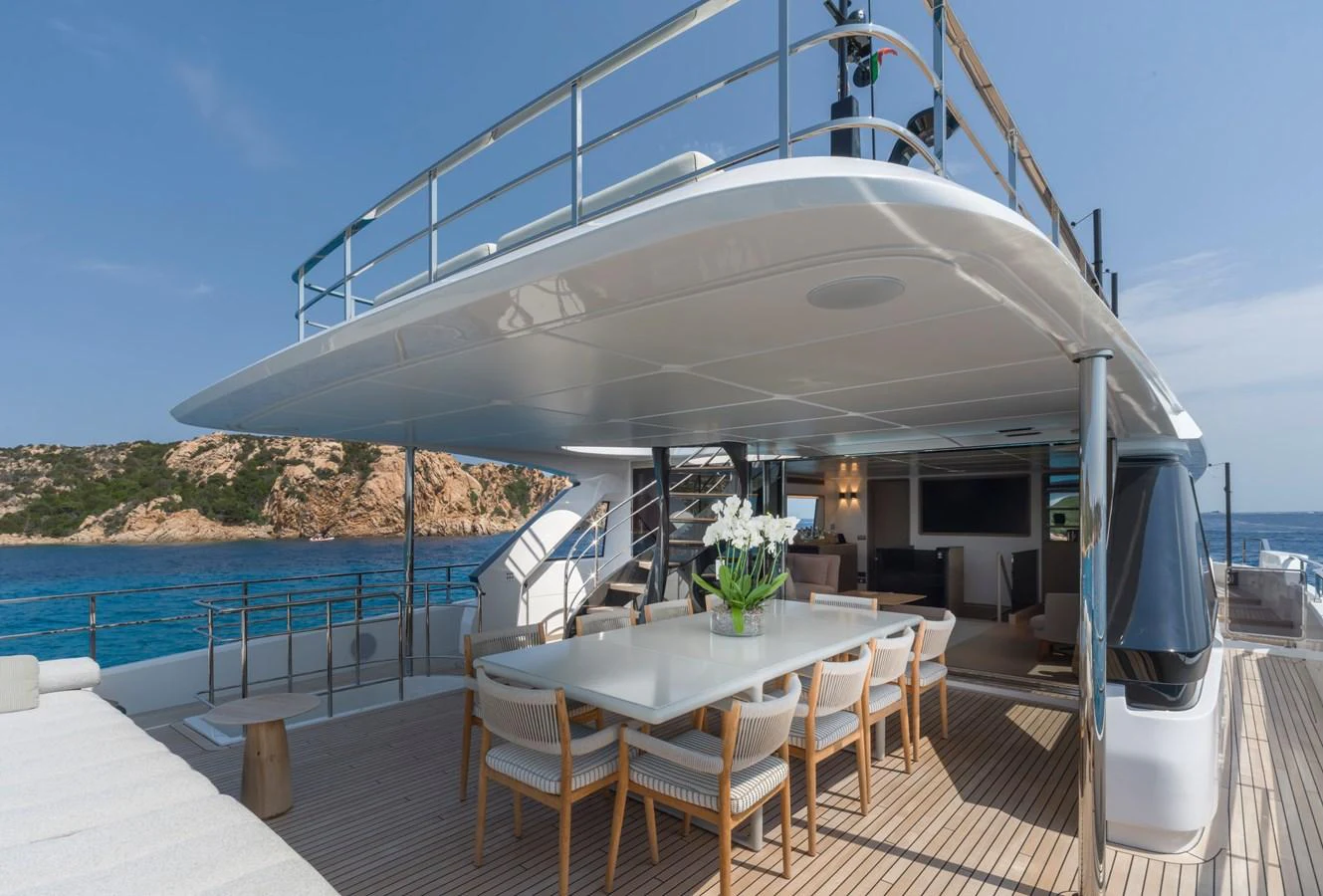 The aft deck features an elegant dining area with a large table and comfortable seating, perfect for al fresco meals. aboard CLAIRE DE LUNE Yacht for Sale