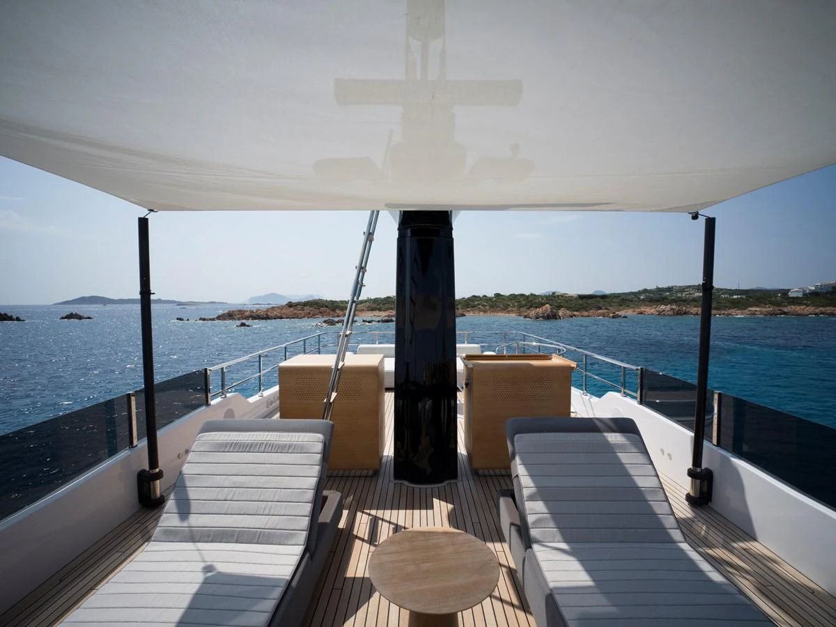 The sundeck offers a relaxing space with comfortable loungers and a shaded area, perfect for enjoying the sea views. aboard CLAIRE DE LUNE Yacht for Sale