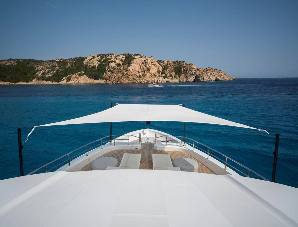 The yacht's foredeck features a spacious lounging area with a sunshade, offering stunning views of the surrounding seascape. aboard CLAIRE DE LUNE Yacht for Sale