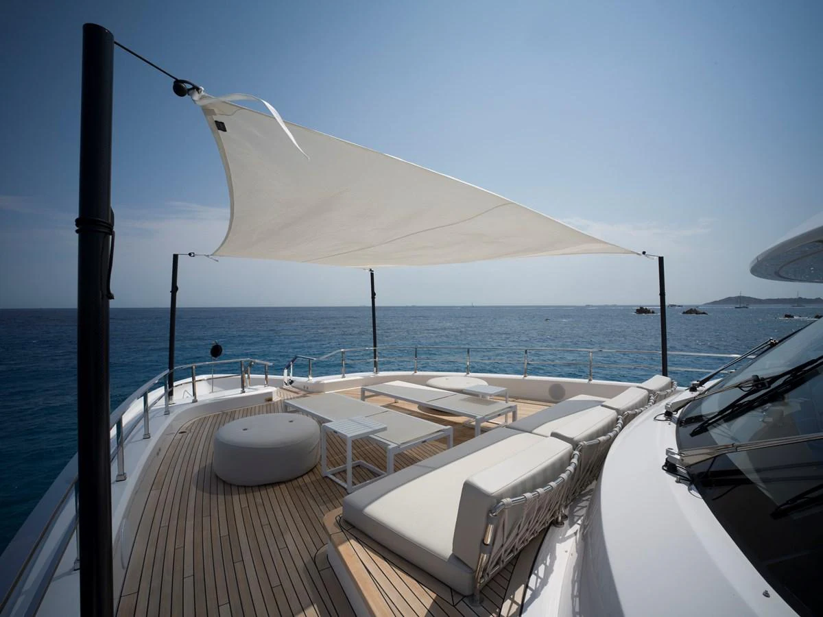 The sundeck offers a luxurious lounging area with a shade sail, perfect for relaxation while enjoying the sea view. aboard CLAIRE DE LUNE Yacht for Sale