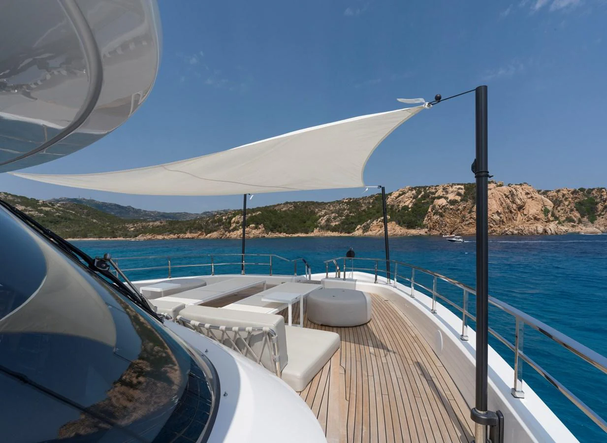 The sundeck offers a luxurious space with comfortable seating and a shade sail, perfect for enjoying scenic views. aboard CLAIRE DE LUNE Yacht for Sale
