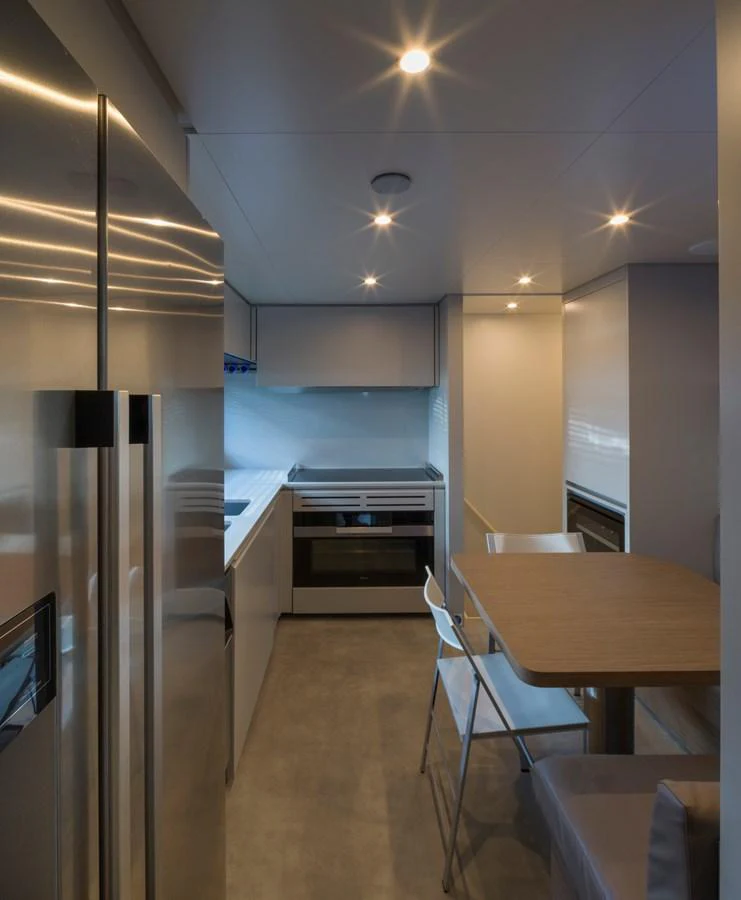 The modern galley features sleek appliances and a cozy dining area. aboard CLAIRE DE LUNE Yacht for Sale