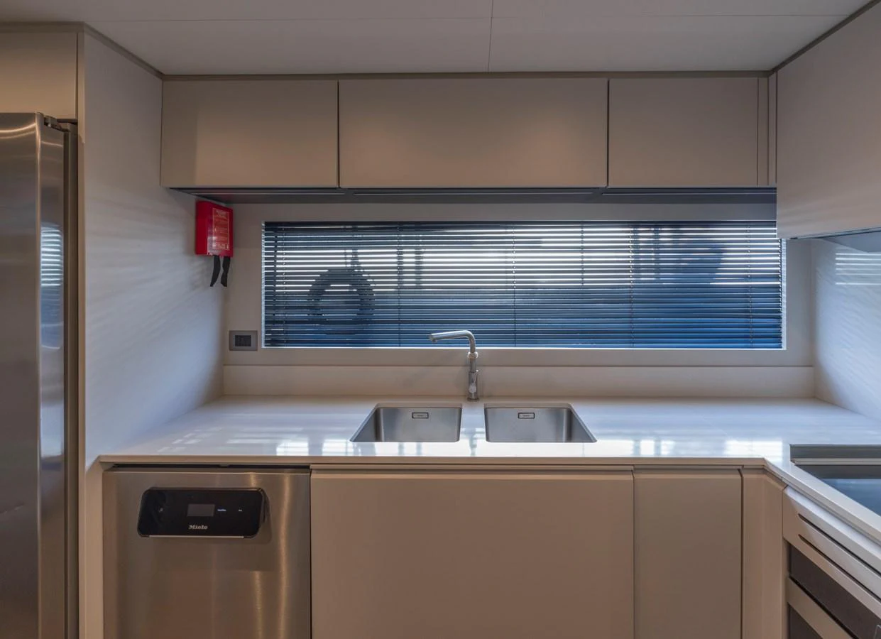 The sleek and modern galley features stainless steel appliances and ample counter space. aboard CLAIRE DE LUNE Yacht for Sale