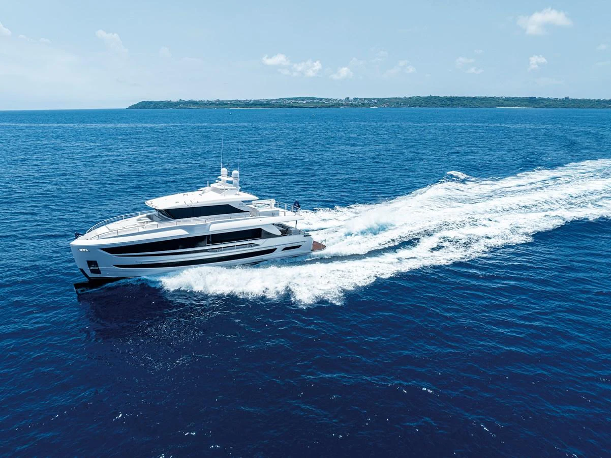 A sleek yacht cruises swiftly across the deep blue ocean under a clear sky. aboard HORIZON FD80/19 Yacht for Sale