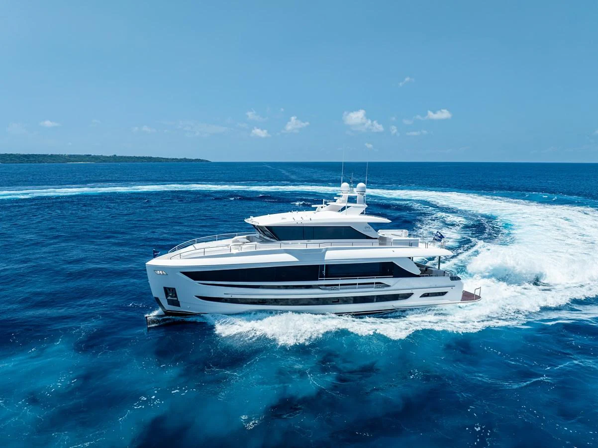 A sleek and modern yacht cruises through vibrant blue waters, leaving a trail of white foam behind. aboard HORIZON FD80/19 Yacht for Sale