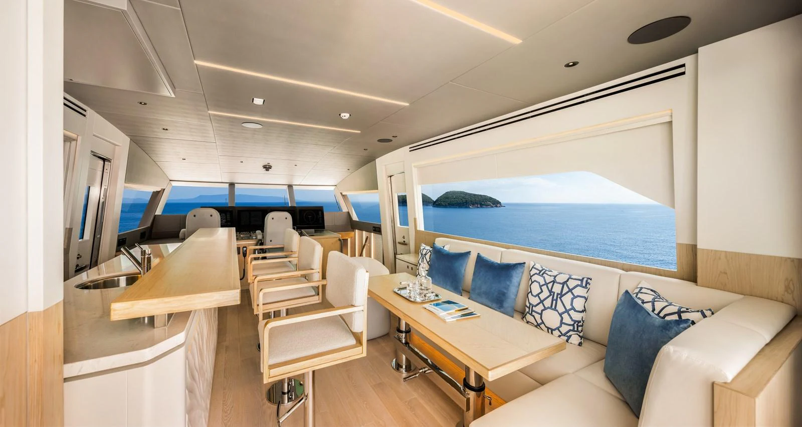 The salon offers a spacious and elegant seating area with panoramic ocean views. aboard HORIZON FD80/19 Yacht for Sale