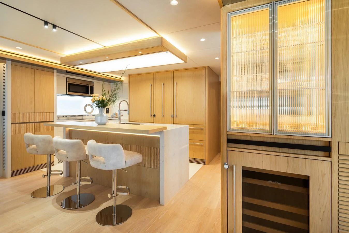 The yacht's galley features a modern design with light wood finishes and a spacious layout. aboard HORIZON FD80/19 Yacht for Sale
