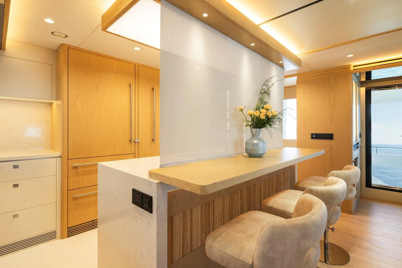 The galley features a sleek design with modern appliances and a cozy breakfast bar. aboard HORIZON FD80/19 Yacht for Sale