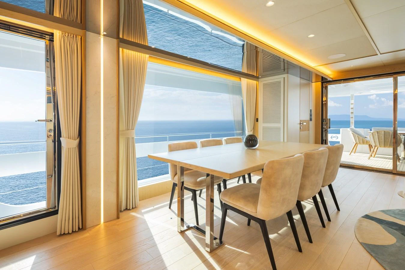 The yacht's dining area offers stunning ocean views through large windows, creating an elegant and serene atmosphere. aboard HORIZON FD80/19 Yacht for Sale