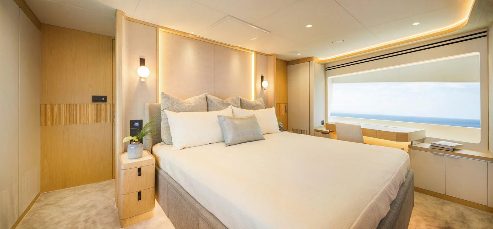 The master stateroom features a luxurious bed with a stunning ocean view through a large window. aboard HORIZON FD80/19 Yacht for Sale