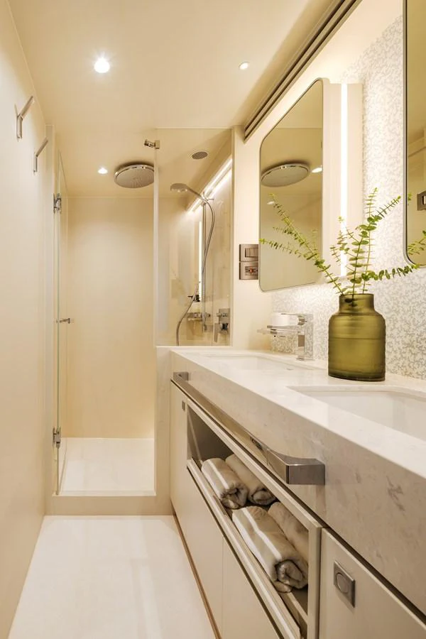 A sleek and modern yacht bathroom featuring a spacious shower and elegant vanity. aboard HORIZON FD80/19 Yacht for Sale