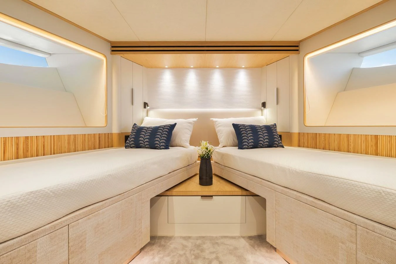 The guest cabin features twin beds with elegant lighting and modern decor. aboard HORIZON FD80/19 Yacht for Sale