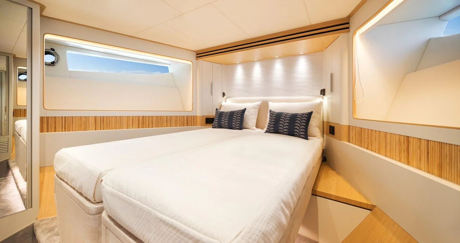 The stateroom features a spacious and well-lit sleeping area with modern design elements. aboard HORIZON FD80/19 Yacht for Sale