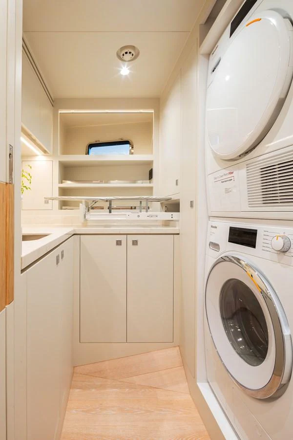A well-equipped laundry room with modern appliances and ample storage space. aboard HORIZON FD80/19 Yacht for Sale