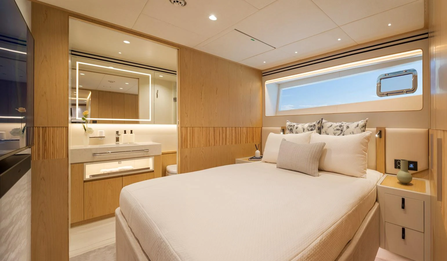 A luxurious stateroom featuring a large bed, modern lighting, and elegant wood finishes. aboard HORIZON FD80/19 Yacht for Sale