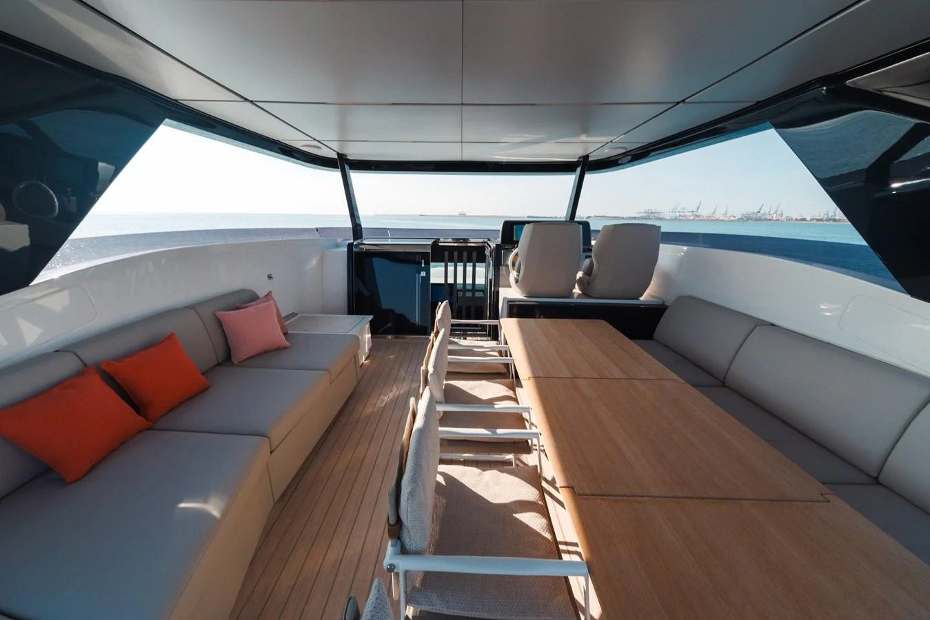 The aft deck features a spacious seating area with a large table, perfect for outdoor dining and relaxation. aboard SEA SAKURA Yacht for Sale