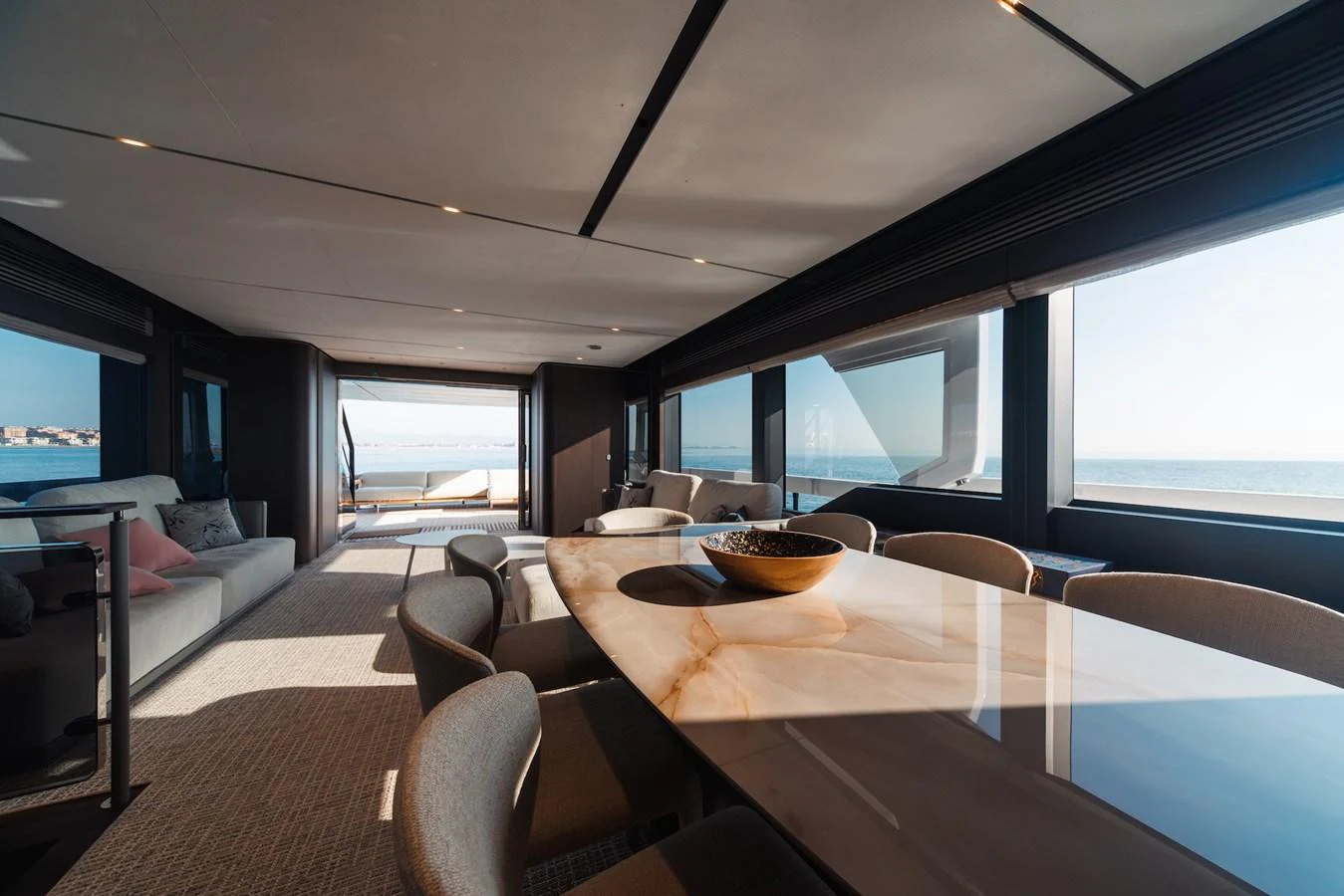 The salon features a spacious dining area with panoramic ocean views. aboard SEA SAKURA Yacht for Sale