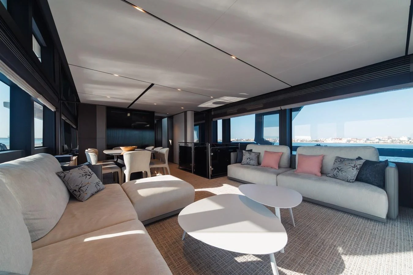 The salon offers a spacious and luxurious seating area with panoramic views. aboard SEA SAKURA Yacht for Sale