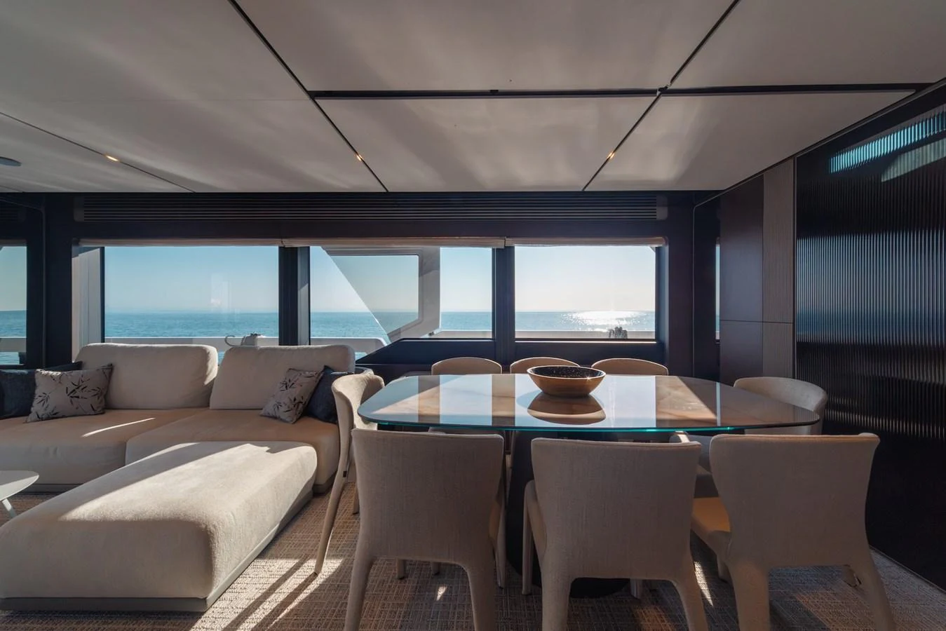 The salon offers a spacious and elegant seating area with panoramic ocean views. aboard SEA SAKURA Yacht for Sale