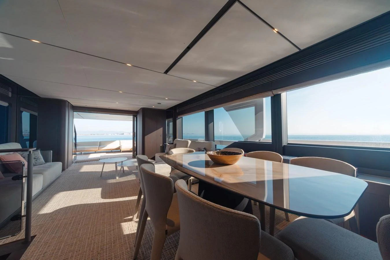 The yacht's dining area offers a spacious and elegant setting with panoramic ocean views. aboard SEA SAKURA Yacht for Sale