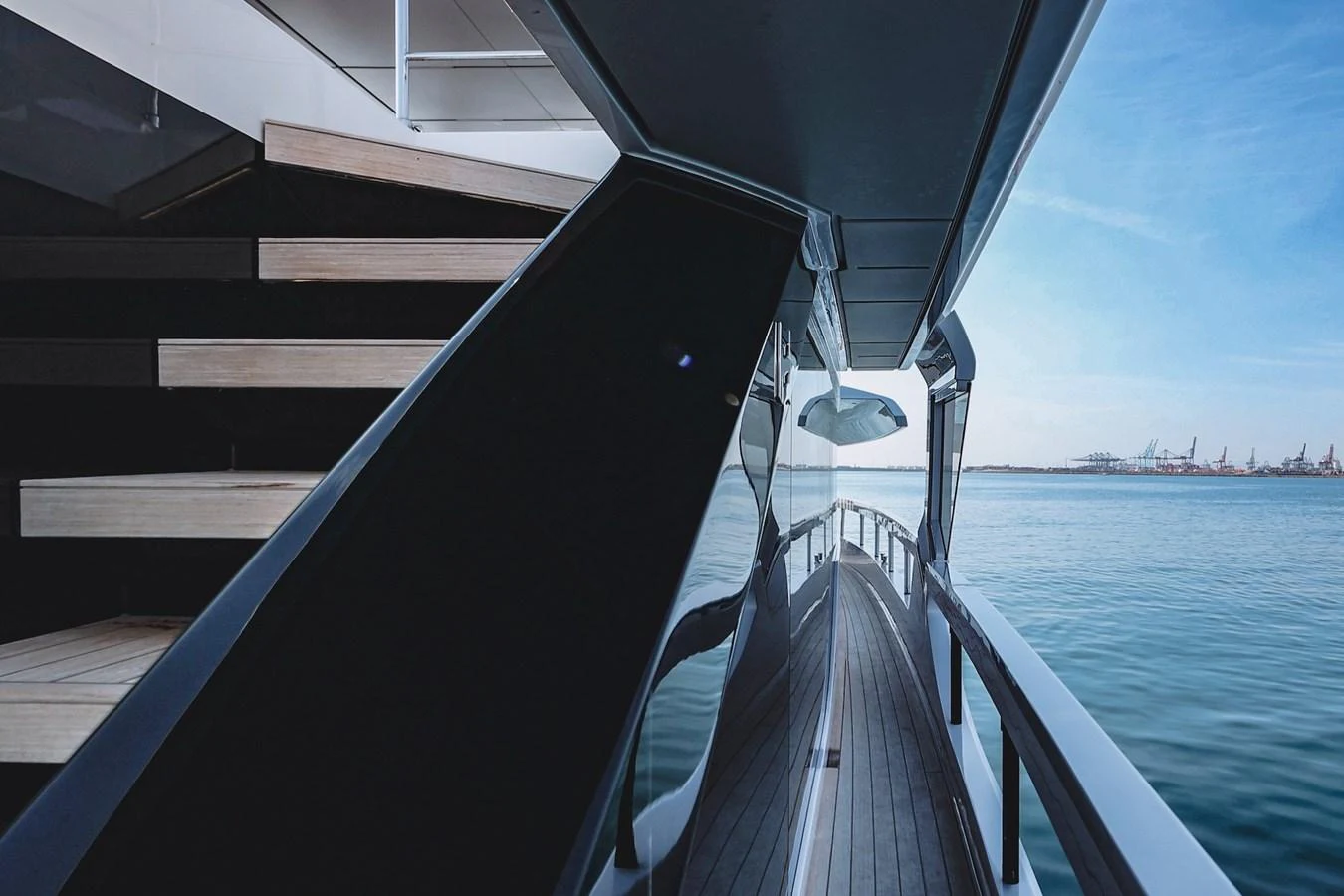 A sleek yacht exterior with a reflective surface and a view of the calm sea. aboard SEA SAKURA Yacht for Sale