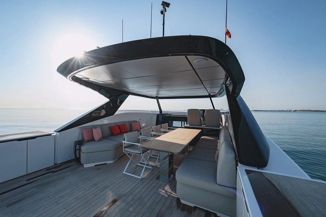 The aft deck features a spacious seating area with a large table, perfect for outdoor dining and relaxation. aboard SEA SAKURA Yacht for Sale