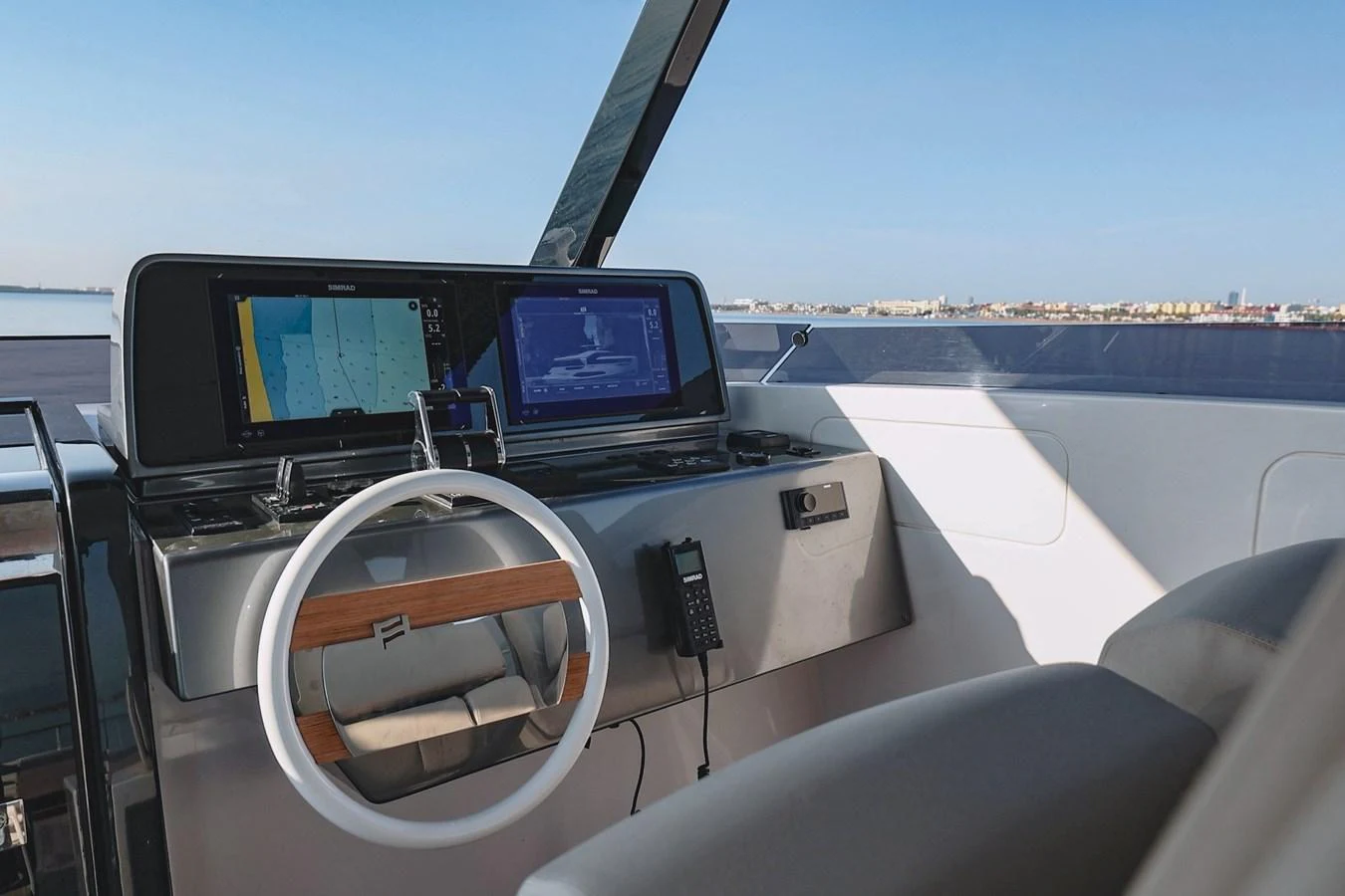 The helm station features modern navigation equipment and a sleek steering wheel, offering a commanding view of the water. aboard SEA SAKURA Yacht for Sale