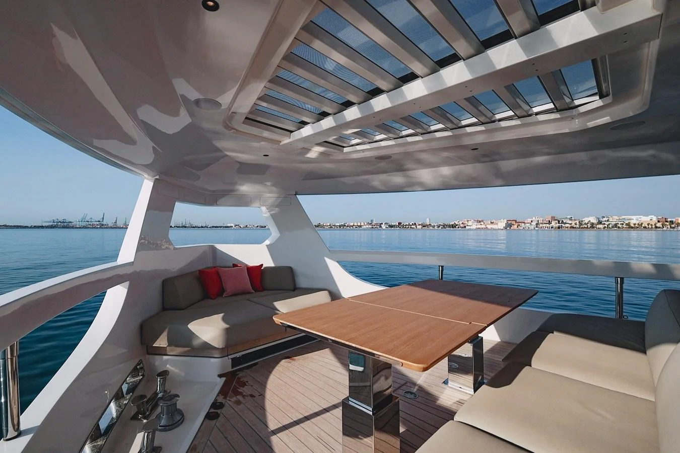 The aft deck features a spacious seating area with a retractable roof, perfect for enjoying the view. aboard SEA SAKURA Yacht for Sale